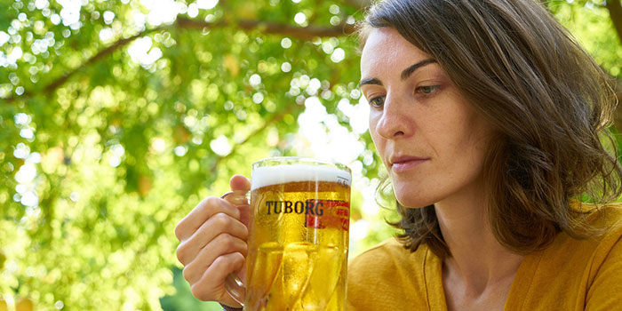 woman looking at the glass of beer